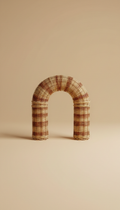 Curved wicker decorative object with sand finish